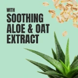 Text reads "With Soothing Aloe & Oat Extract" on a light green background. Bottom shows fresh aloe leaves with water droplets; top right has oat flakes.