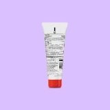 White tube with a red cap on a lavender background. The tube displays text and a barcode, indicating product details and ingredients.