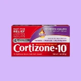 Cortizone-10 anti-itch cream box on a lavender background. Red packaging with text highlighting fast itch relief, eczema, psoriasis, and dry skin.