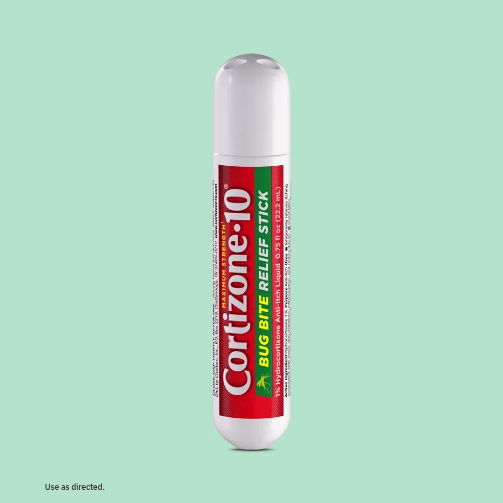Cylindrical Cortizone-10 bug bite relief stick with red and green label on a light green background. Text includes "use as directed."