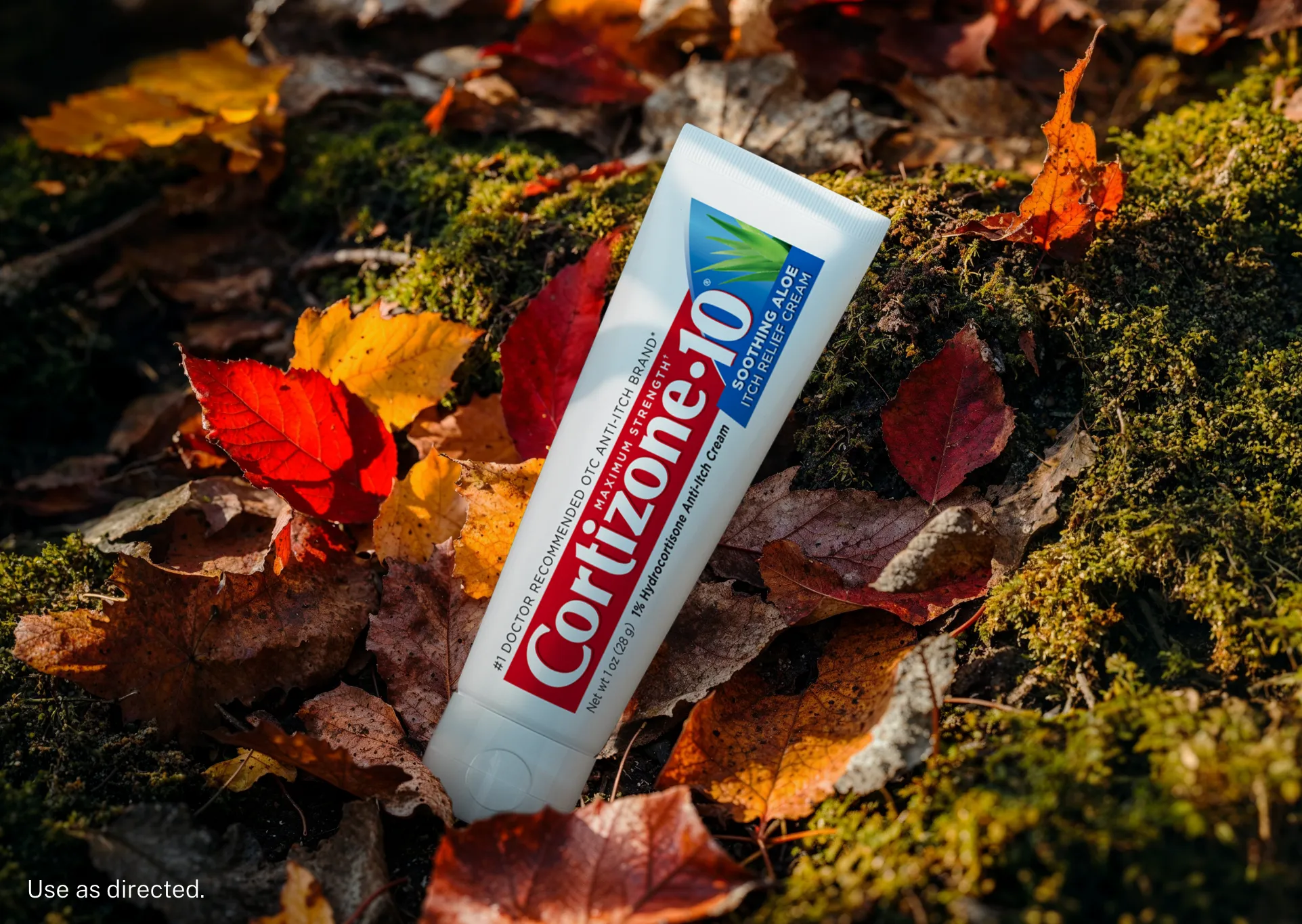 Tube packaging of a best-selling Cortizone-10® product: Maximum Strength† Itch Relief Soothing Aloe Cream in an outdoor landscape that features leaves and moss.